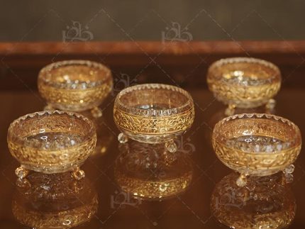ساخته‌شده از کریستال ۲۴ درصد با طلاکاری ۱۲ عیار پیاله با ارتفاع ۶ و قطر ۱۲ سانتی‌متر پیش‌دستی با ارتفاع ۳ و قطر ۱۸ سانتی‌متر طراحی لوکس و مناسب سرو آجیل، دسر و شیرینی حکاکی‌های امیخ و کار دست با جزئیات هنری کیفیت بالا و مقاوم در برابر خط و خش براقیت و درخشندگی چشمگیر در هر نور دارای گارانتی مادام‌العمر و ضمانت اصالت ست کامل شش‌عددی پیاله و شش‌عددی پیش‌دستی انتخابی ایده‌آل برای سرویس جهازیه و پذیرایی